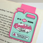 Bookish Fuel magnetic bookmark clipped to an open book page