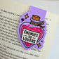 Enemies to Lovers magnetic bookmark clipped to an open book page