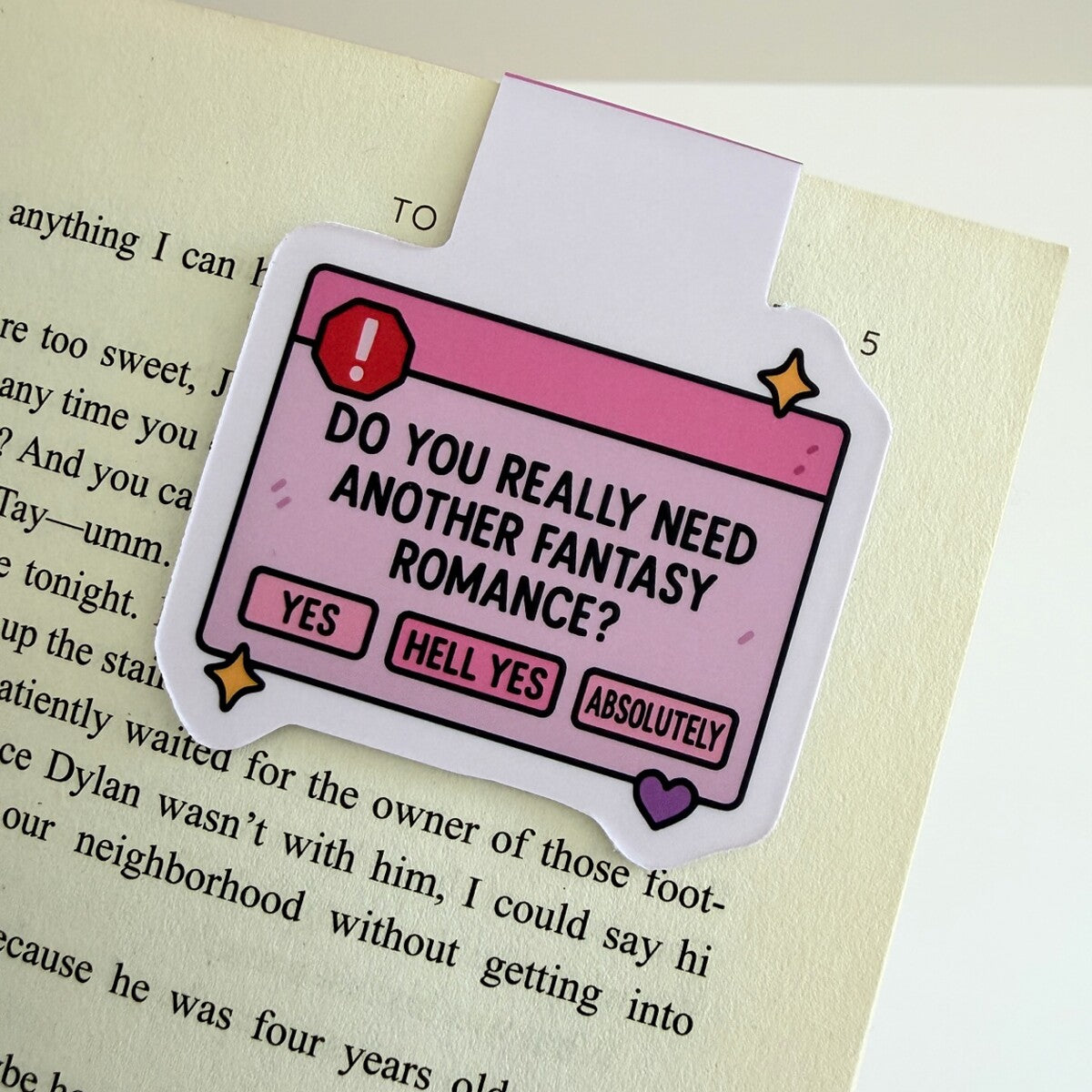 Fantasy Fix magnetic bookmark clipped to an open book page