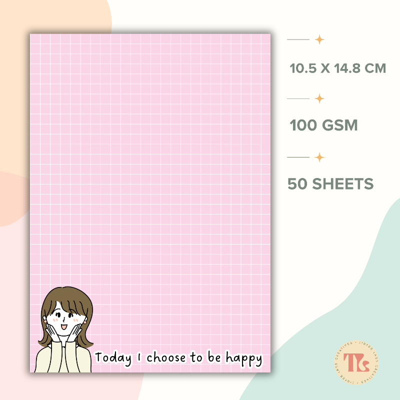 Pink A6 affirmation notepad with a grid design, featuring an illustration of a smiling woman and the motivational phrase 'Today I choose to be happy.' Includes 50 sheets of 100 GSM premium paper, perfect for notes, journaling, or planning.